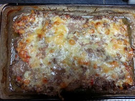 Edges pulled away from the sides of the baking dish and the cheese is beautifully melted. Finished meatloaf.