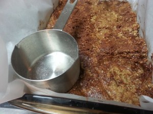 Measuring cup PUSHING down the granola mix...