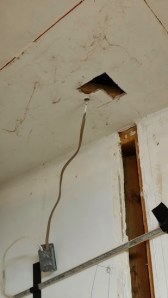 Hole we found in the ceiling with wiring cut into another whole....